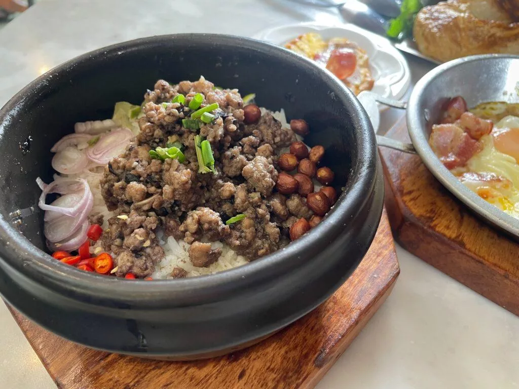 Stir-fried minced pork with black Chinese olive in the rice bowl 