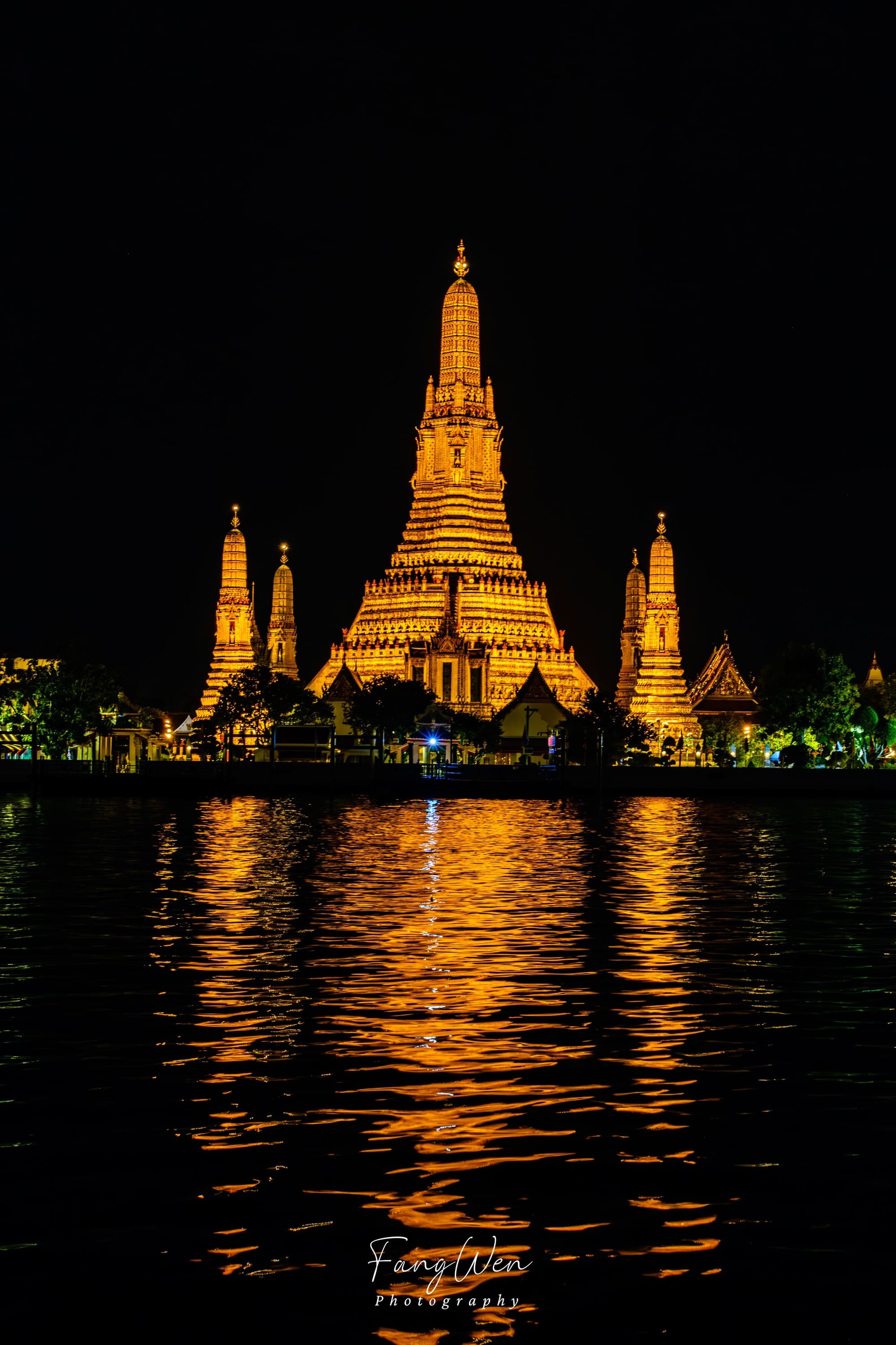 Night view of Wat Arun across the river